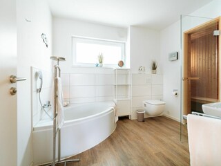 Badezimmer mit Sauna und ebenerdiger Dusche