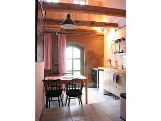 Kitchen with steps to a bunk bed