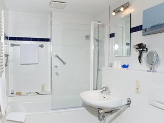 Bathtub with glass divider and towel heater