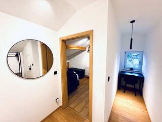 Hallway with view of corridor with desk