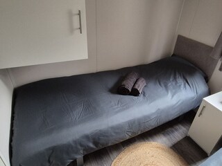 Each bed has a bedside table with a reading lamp.