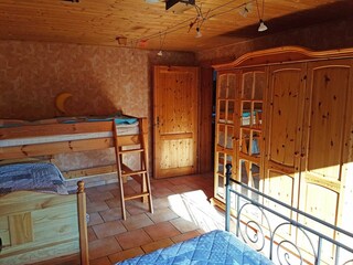 Schlafraum mit Doppelbett, Hochbett und Einzelbett