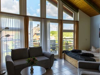 1-Raum-Appartement mit Sitzbereich und Doppelbett