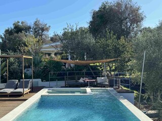Pool area with lounge and sunbeds