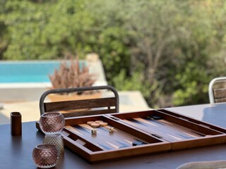 Backgammon by the pool with a view of the greenery