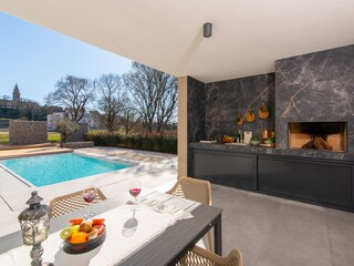 Outdoor kitchen, terrace and pool view