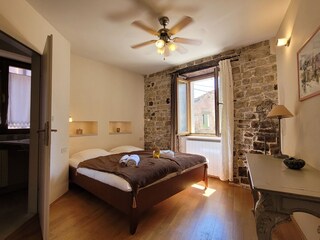 Sleeping room with double bed and small Bathroom