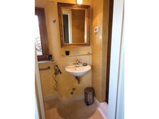 small bathroom with shower, sink and WC