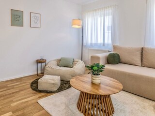 Geräumiges Wohnzimmer mit Couch, Smart TV und gemütlich