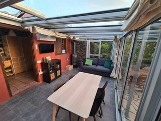 Dining table, sofa in the winter garden