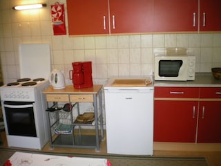 Ground-floor kitchen with upholstered seating area.
