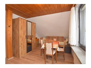 Bedroom with seating area and single bed.