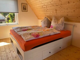 180-cm-wide box spring bed in the attic studio