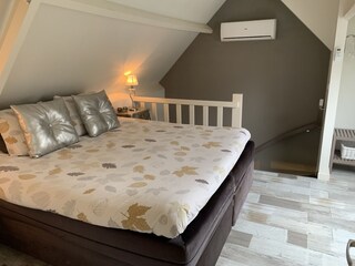 Das Schlafzimmer mit Kingsize-Bett und Klimaanlage