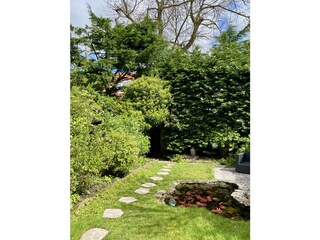 The studio is surrounded by a beautiful green garden