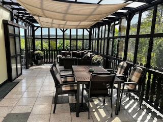 Wintergarten mit Sitzlounge und Essbereich