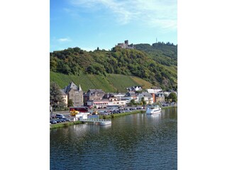 The Moselle shore with passenger ships & the ruins of Landshut Castle
