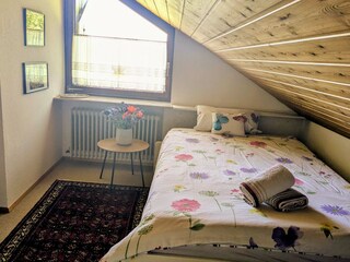 View of the upstairs bedroom showing the 140x200 cm bed