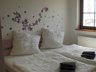 Schlafzimmer mit Doppelbett, großer Kleiderschrank