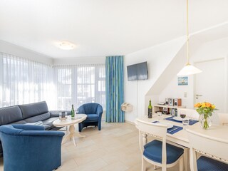 A bright, spacious living room with a sunny balcony