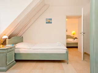 cosy bedroom 2 with chest of drawers and wardrobe