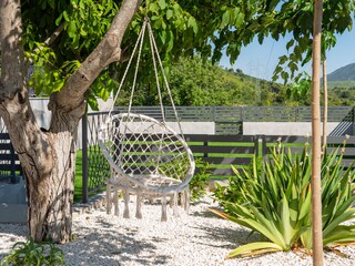 Garden in a flower landscape with a swing