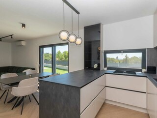 Large sliding doors open onto the covered terrace