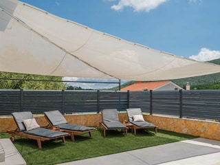 Surrounded by sun loungers and parasols