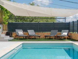 sun deck area with 4 sun loungers and three beach chair
