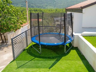 a trampoline and playground provide hours of fun
