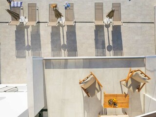 A terrace overlooking the pool and natural surroundings