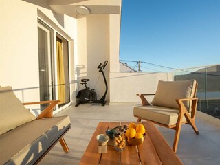 A terrace overlooking the pool and natural surroundings