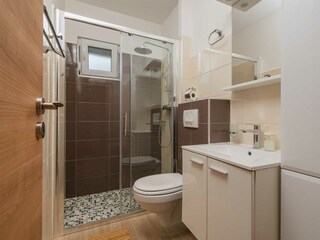 Bathroom with shower next to the living space.