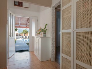 Hallway opens directly onto a covered terrace.