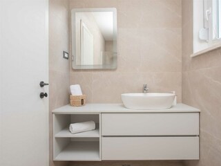 The two bedrooms share a stylish bathroom.