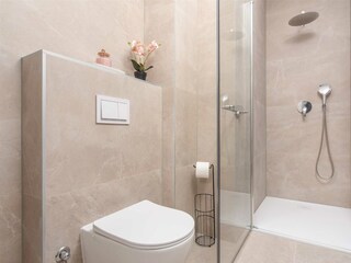 The two bedrooms share a stylish bathroom