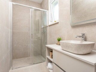 The en suite bathroom features a contemporary style