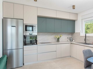 The villa features a sleek, fully equipped kitchen