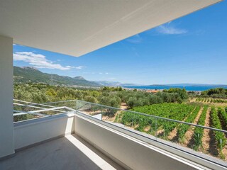 From the balcony, enjoy sweeping views of the vineyard