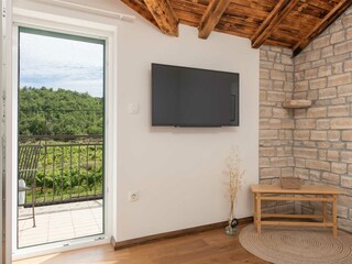 Room has a television, and access to a balcony.
