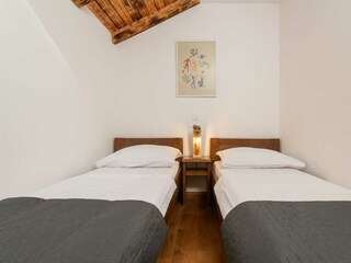 Bedroom 3 is furnished with two single beds