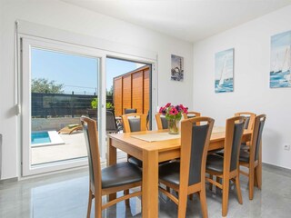 A wooden dining table serves as a perfect spot