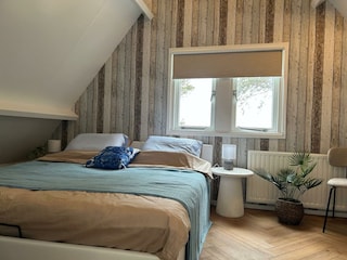 Master bedroom with a comfortable king-size bed.