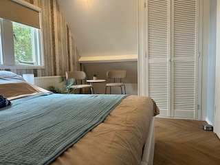 Spacious wardrobe with fold-down bed and iron.