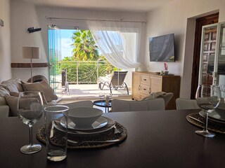 The glass front opens the living room to the terrace.