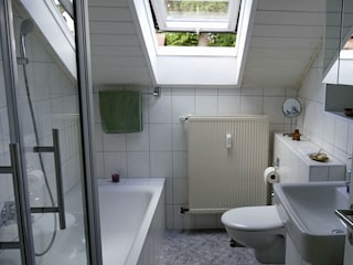 Badezimmer mit Badewanne und Dusche