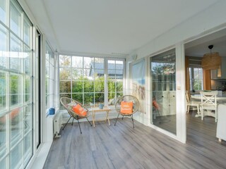 Der Wintergarten mit Kamin und Sesseln