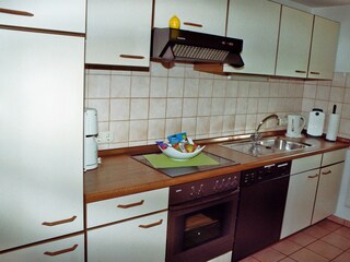 Fitted kitchen and dining room with dining table and 4 chairs