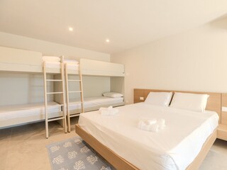 Bedroom with double bed and 2 bunk beds