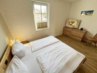 1. Schlafzimmer mit Doppelbett und TV
